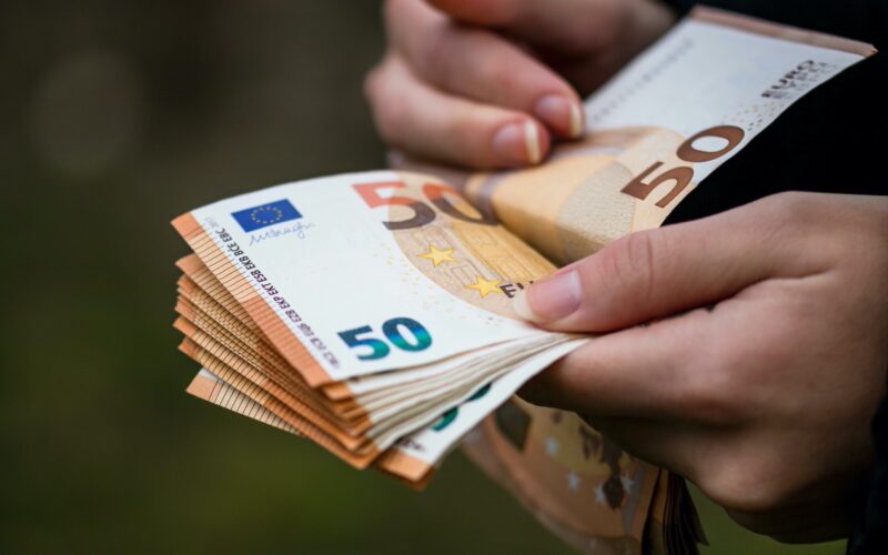 closeup-female-hands-counting-euro-banknotes-world-money-inflation-economy-concept